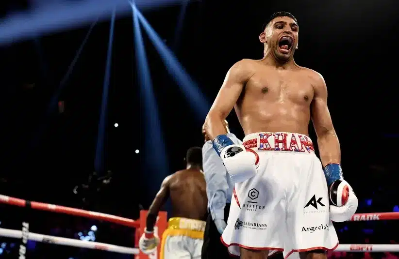 Amir Khan (white trunks) reacts between rounds.