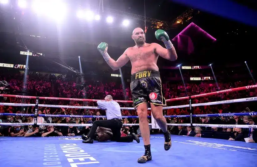 Deontay Wilder (red/black trunks) is knocked out by Tyson Fury (black/gold trunks.