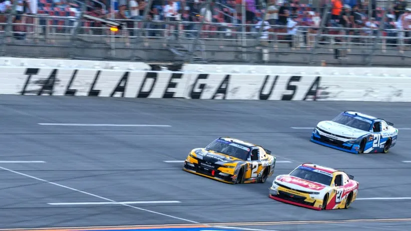 Apr 26, 2025; Talladega, Alabama, USA; Xfinity Series driver Jesse Love (2) and Xfinity Series driver Jeb Burton (27) fight going into turn one at Talladega Superspeedway.