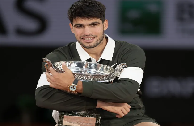 Carlos Alcaraz of Spain poses with the trophy after winning the men’s singles final.