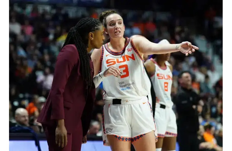 Marina Mabrey talking with one of her coaches during a game last season.