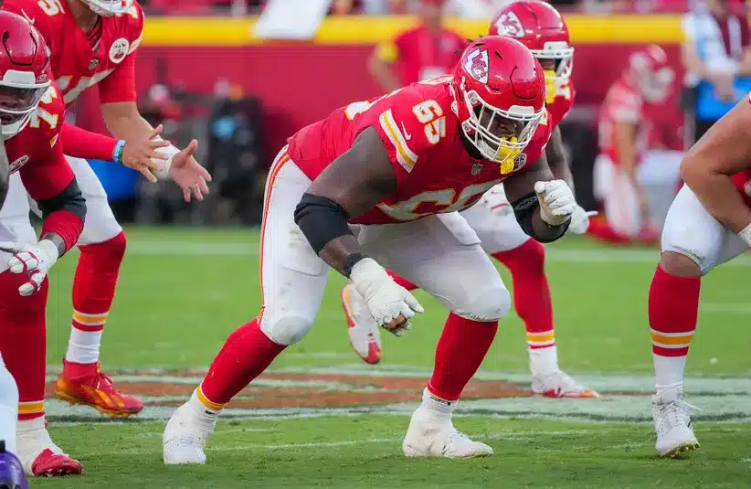 Kansas City Chiefs guard Trey Smith (65) at the line of scrimmage against the Baltimore Ravens during the game at GEHA Field at Arrowhead Stadium