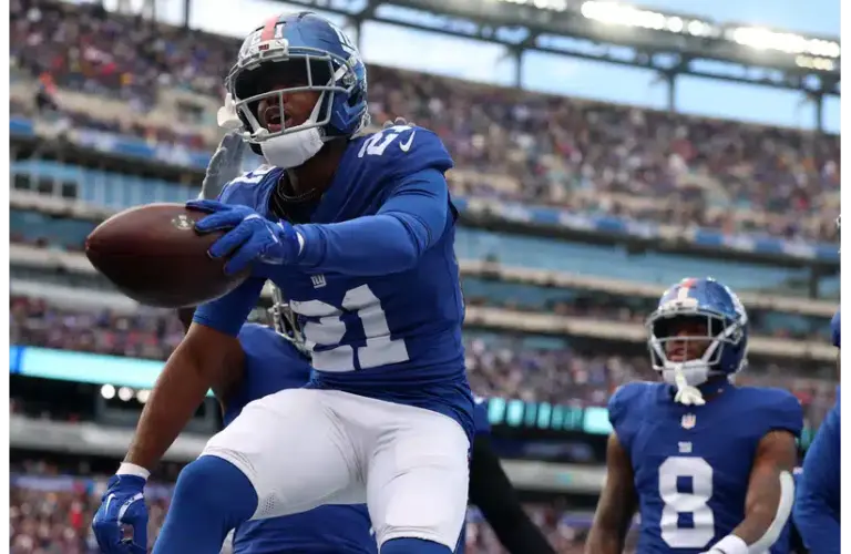 Giants Paulson Adebo jumping on the field