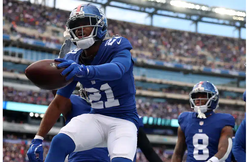 Giants Paulson Adebo jumping on the field