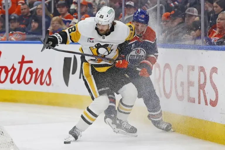 Jan 22, 2026; Edmonton, Alberta, CAN; Pittsburg Penguins defenseman Parker Wotherspoon (28) and Edmonton Oilers forward Zach Hyman (18) battle along the boards for a loose puck during the third period at Rogers Place.