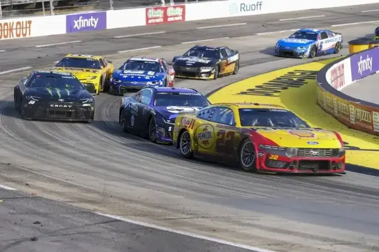 Cup Series; Mar 29, 2026; Martinsville, Virginia, USA; Team Penske driver Joey Logano (22) passes driver Ross Chastain (1) out of turn four at Martinsville Speedway.