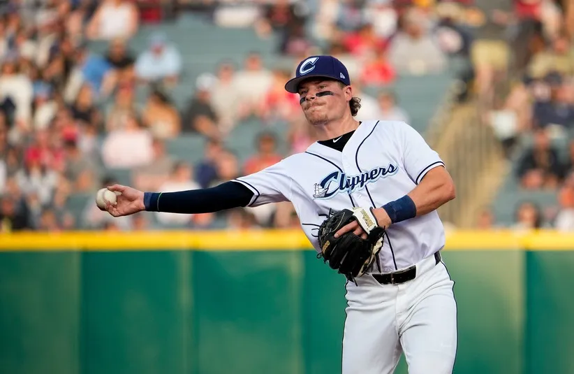 Columbus Clippers Travis Bazzana (12) throws the ball to first base.