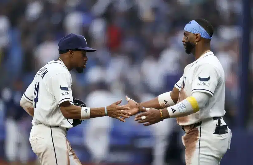 Tampa Bay Rays center fielder Chandler Simpson (14) and designated hitter Yandy Diaz (2) react after beating the Chicago Cubs. The duo led the Rays against the Yankees.