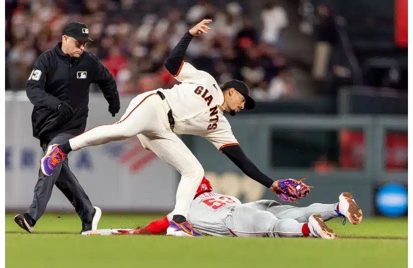 Giants infielder Willy Adames tries to tag a player out