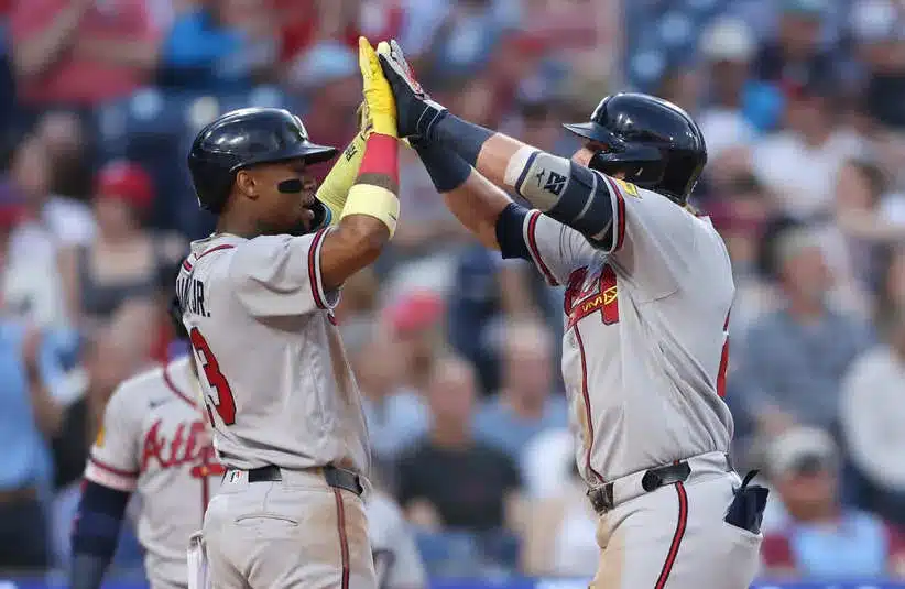 Atlanta Braves third baseman Austin Riley (27) high fives right fielder Ronald Acuna Jr. (13).