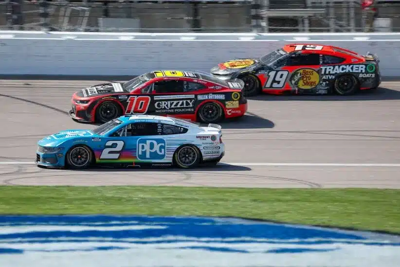 Apr 19, 2026; Kansas City, Kansas, USA; NASCAR Cup Series drivers Austin Cindric (2), Ty Dillon (10) and Chase Briscoe (19) race during the AdventHealth 400 at Kansas Speedway.
