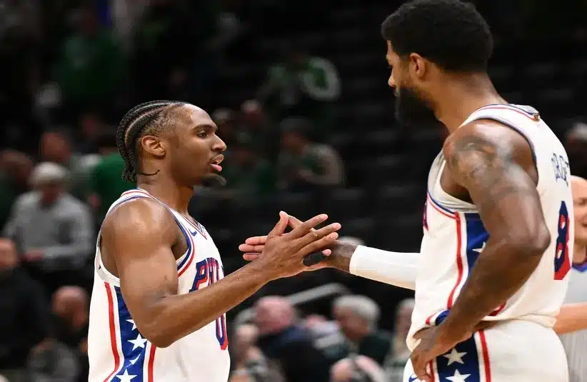Philadelphia 76ers guard Tyrese Maxey (0) high-fives forward Paul George (8) after a game.
