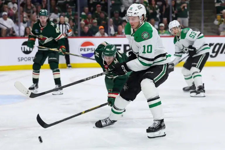 Apr 22, 2026; Saint Paul, Minnesota, USA; Dallas Stars center Oskar Back (10) and Minnesota Wild defenseman Jared Spurgeon (46) compete for the puck during the first overtime period in game three of the first round of the 2026 Stanley Cup Playoffs at Grand Casino Arena.
