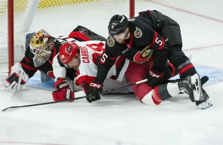 Carolina Hurricanes left wing William Carrier (28) is taken down as he battles with Ottawa Senators defenseman Cameron Crotty (5).
