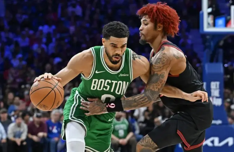 Boston Celtics forward Jayson Tatum (0) is defended.
