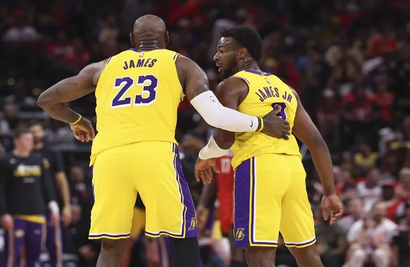 Los Angeles Lakers forward LeBron James (23) and guard Bronny James (9) react.