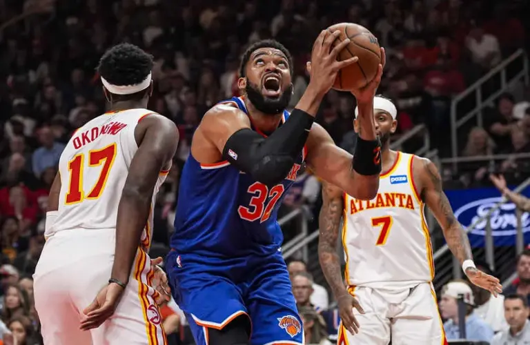 New York Knicks center Karl-Anthony Towns (32) tries to reach the basket.