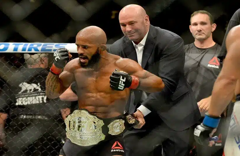 UFC president Dana White puts the championship belt on Demetrious Johnson.