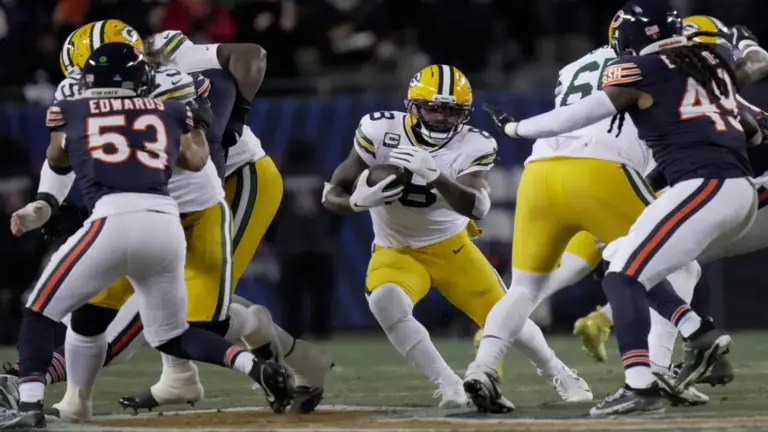 Green Bay Packers running back Josh Jacobs (8) finds a seam
