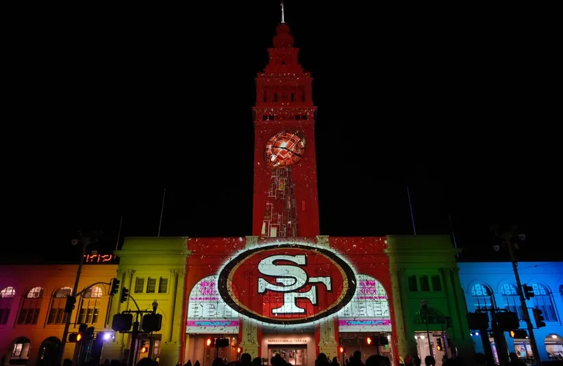 The San Francisco 49ers logo is projected on the Ferry Building.