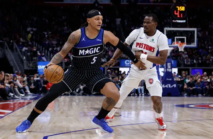 Orlando Magic forward Paolo Banchero (5) dribbles defended by Detroit Pistons guard Javonte Green (31) in the first half during game five of the first round of the 2026 NBA Playoffs.