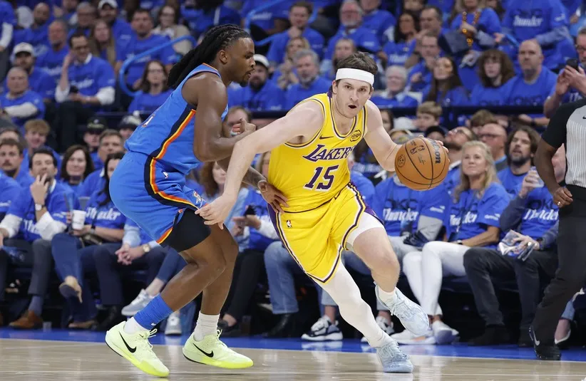 Los Angeles Lakers guard Austin Reaves (15) drives around Oklahoma City Thunder guard Cason Wallace (22). Detroit Pistons
