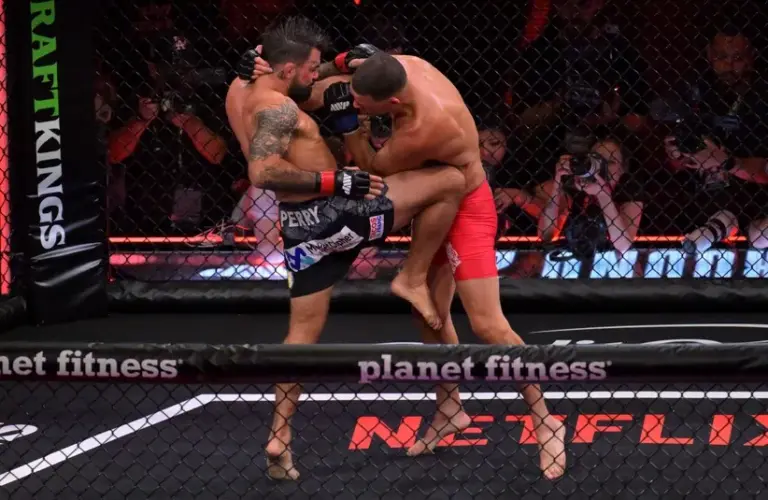 Nate Diaz (blue gloves) fights Mike Perry (red gloves) in a welterweight bout.