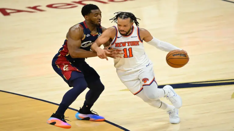 New York Knicks guard Jalen Brunson (11) moves the ball against Cleveland Cavaliers guard Donovan Mitchell (45).