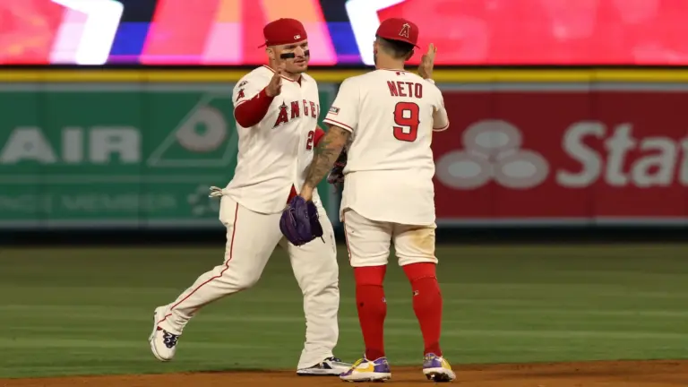 Los Angeles Angels center fielder Mike Trout (left) celebrates with shortstop Zach Neto (9).