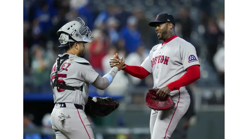 Aroldis Chapman celebrating with Red Sox catcher. The Red Sox hope he can get in the game against the Yankees.