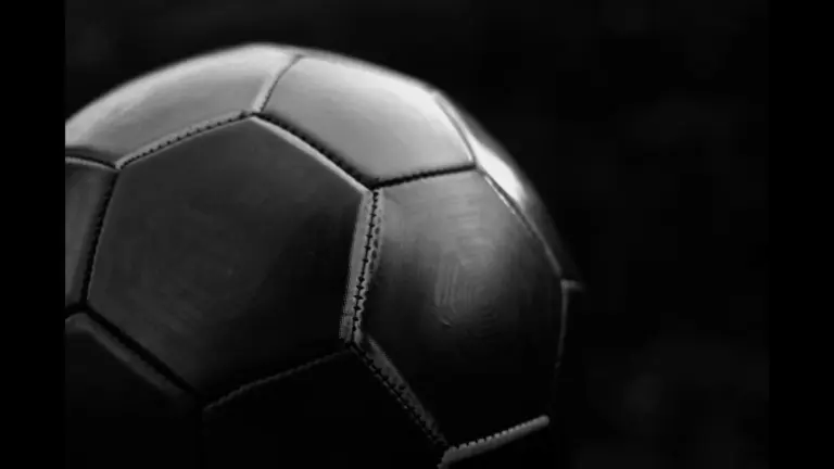 Picture of a soccer ball in black and white with a black background. FIFA has many soccer rules that fans don't know about.