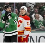 Apr 7, 2026; Dallas, Texas, USA; Dallas Stars left wing Jamie Benn (14) and Calgary Flames center Mikael Backlund (11) look on as the referees check the replay of a hit by defenseman Tyler Myers (not pictured) during the third period at the American Airlines Center. Mandatory Credit: Jerome Miron-Imagn Images