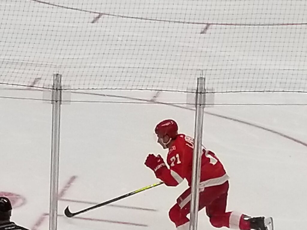Detroit Red Wings center Dylan Larkin skates during a 2018 home game; a Dylan Larkin injury will keep him out of the first two games of 2026-27