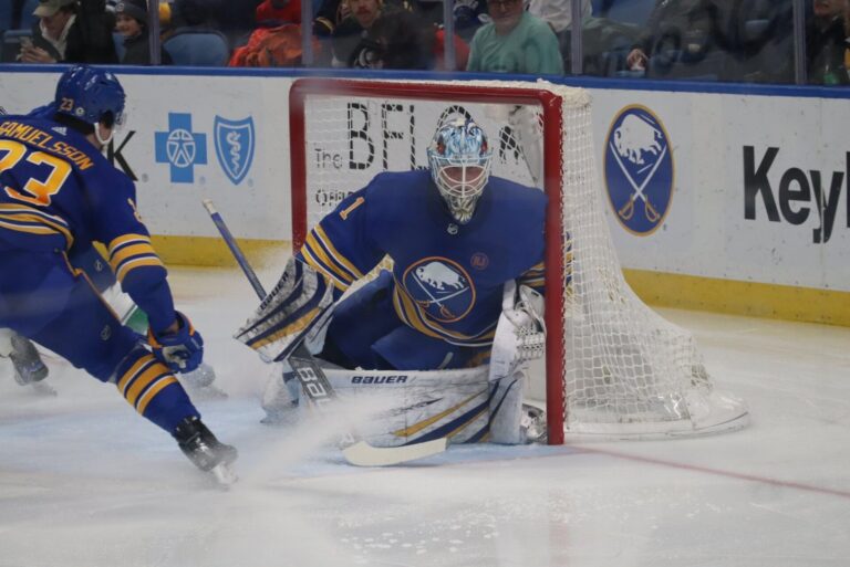 Sabres goaltender Ukko-Pekka Luukkonen hugs the post as defenseman Mattias Samuelsson turns during a January 2024 game against Vancouver